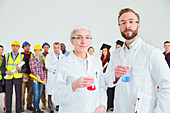 Scientists with workforce in background