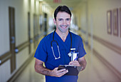 Portrait of male doctor holding clipboard