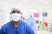 Surgeon wearing surgical mask and cap