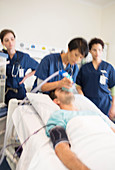 Doctors giving oxygen to patient