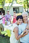 Couple hugging at party