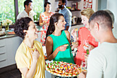 Woman serving friends at party