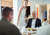 Couple laughing at dinner party