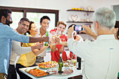 Man taking picture of friends at party