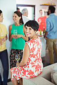 Woman smiling on sofa at party