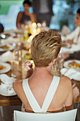 Woman sitting at dinner party