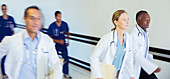Doctors and nurses rushing hallway
