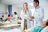 Doctors talking to patient room