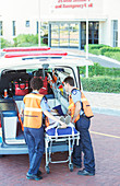 Paramedics wheeling patient