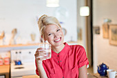 Woman having glass of water in kitchen