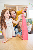 Students and teacher stacking blocks