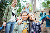 Students and teachers smiling in forest