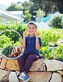 Boy with basket of produce in garden