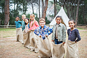 Children smiling at start of sack race