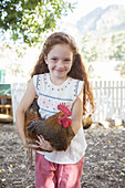 Girl holding chicken at petting zoo