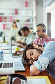 Man sleeping at desk in office