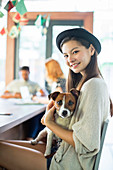 People holding dog at conference table