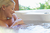 Woman relaxing in hot tub