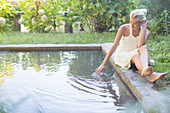 Woman relaxing by pool