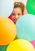 Young girl surrounded by balloons