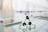 Molecular model and tablet on counter