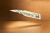 20 dollar bill folded into paper airplane