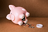 Piggy bank spilling out change