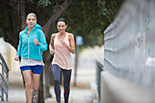 Women running through city streets