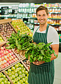 Clerk carrying basket of produce