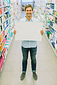 Man holding blank card aisle