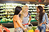 Women shopping together in grocery store