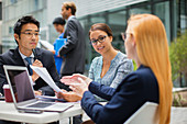 Business people talking at outdoor table