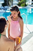 Mother applying sunscreen