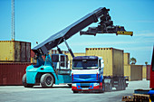 Crane near cargo container on truck