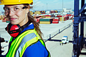 Worker smiling near cargo containers