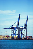 Cranes and cargo containers at waterfront