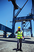 Worker talking near cargo crane