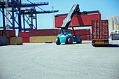Crane lifting cargo container