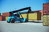 Crane lifting cargo container