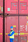 Worker smiling near cargo containers