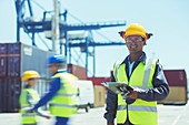 Worker standing near cargo containers