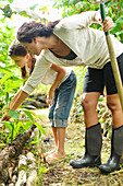 Woman and girl inspecting at plants