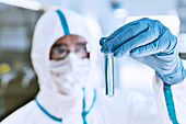 Scientist examining sample in test tube