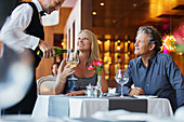 Mature couple sitting at restaurant table