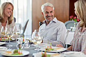 Smiling people enjoying their meal