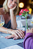 Couple holding hands in restaurant