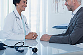 Smiling female doctor talking to patient