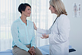 Smiling female doctor talking to patient