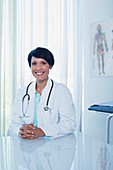 Portrait of smiling female doctor at desk