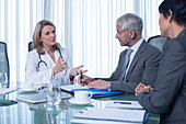 Female doctor, man and woman talking